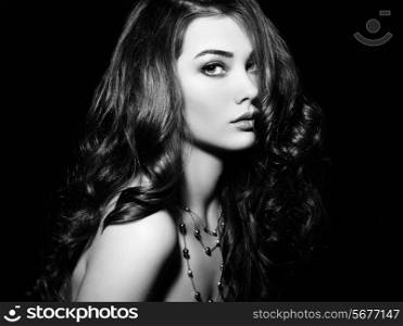 Beauty woman with long curly hair. Beautiful girl with elegant hairstyle. Fashion photo. Black and white
