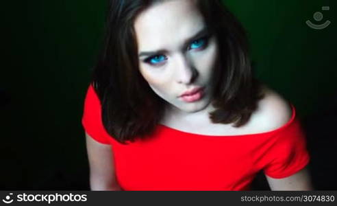 Beauty woman with mesmerising eyes and red dress