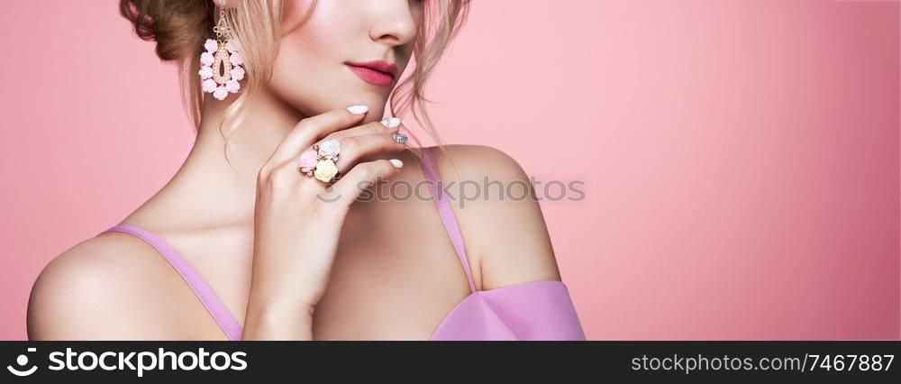 Beauty Woman with perfect Makeup and Manicure. Glamour Girl with Jewelry. Pink Lips and Nails. Precious Stones and Silver. Beauty girls Face isolated on light Background. Fashion photo