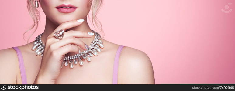 Beauty Woman with perfect Makeup and Manicure. Glamour Girl with Jewelry. Pink Lips and Nails. Precious Stones and Silver. Beauty girls Face isolated on light Background. Fashion photo