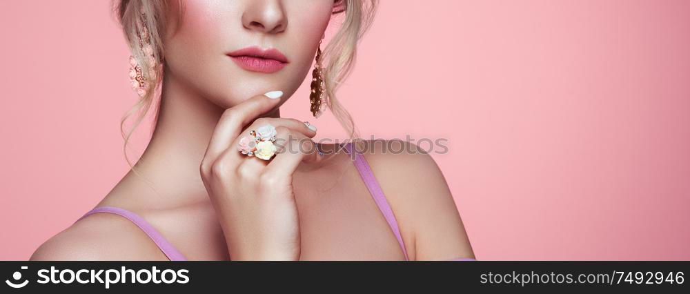 Beauty Woman with perfect Makeup and Manicure. Glamour Girl with Jewelry. Pink Lips and Nails. Precious Stones and Silver. Beauty girls Face isolated on light Background. Fashion photo