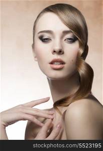beauty woman with perfect skin, cute make-up and shiny brown hair-style with wavy tuft near the visage