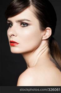 Beauty woman with red lips and smokey eyes on black background. Natural portrait. Healthy leaving. Classic photography