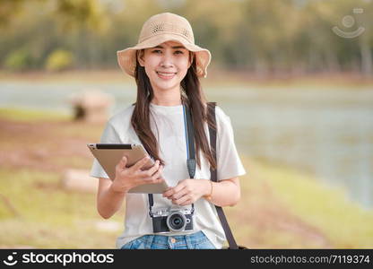 Beauty women holding tablet with camera travel take photo