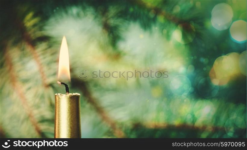 Beauty Xmas banner with golden candle against fir tree and bokeh