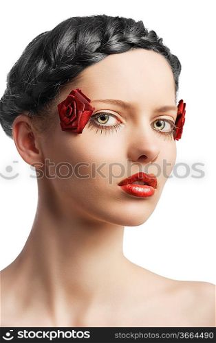 beauty young girl with a floral makeup. She is turned of three quarters and looks in to the lens with attractive expression