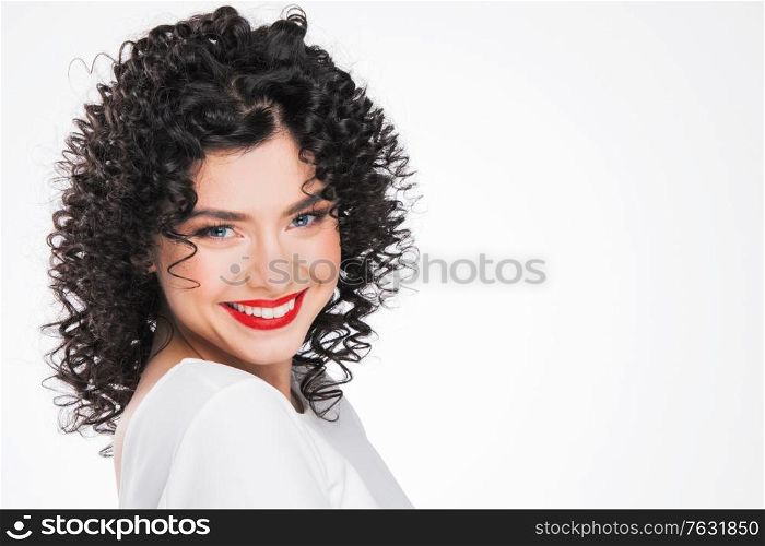 Beauty young woman portrait isolated on white background. Girl with black curly hair. Hairstyle. Haircut. Model girl with curly hair