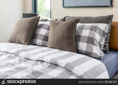 bed and brown pillows in modern bedroom. bed and brown pillows in modern bedroom