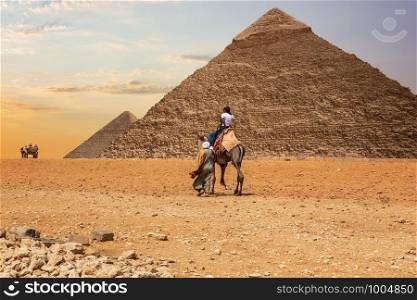 Bedouins in Giza desert near the Great Pyramids of Egypt.. Bedouins in Giza desert near the Great Pyramids of Egypt