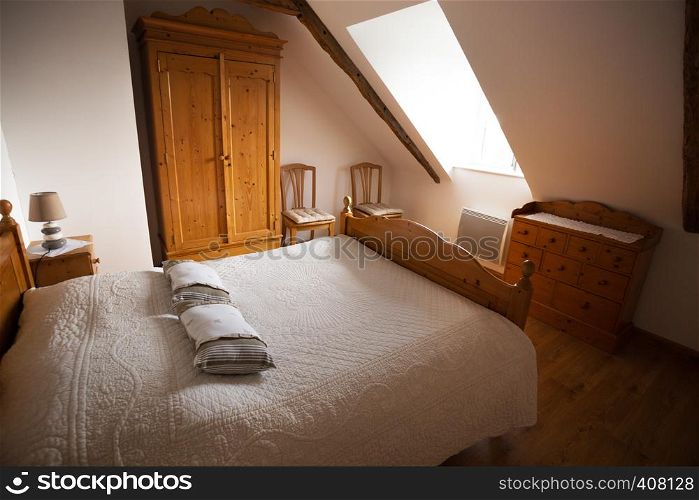 Bedroom and empty large bed in traditional rural style