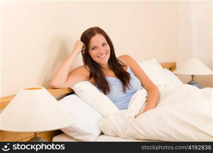 Bedroom - beautiful woman morning waking up sitting on white bed