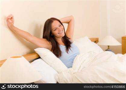 Bedroom - beautiful woman morning waking up stretching on white bed