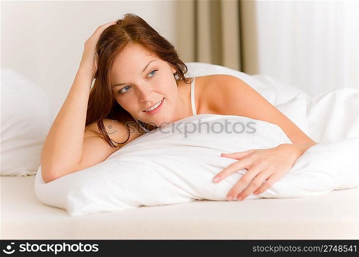 Bedroom - happy woman in white bed waking up