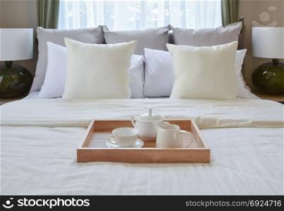 bedroom interior design with decorative tea set and dessert on bed
