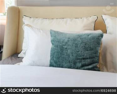 bedroom interior design with white and green pillows on white bed