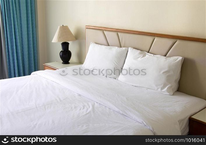 bedroom interior with pillow and table lamp