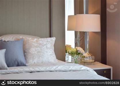 Bedroom interior with pillows and classic reading lamp on bedside table