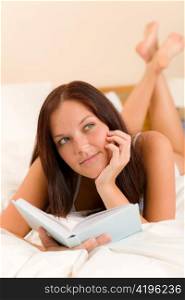 Bedroom thoughtful woman read book in white bed