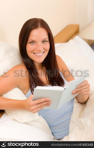 Bedroom - young woman read book in white bed