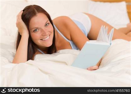 Bedroom - young woman read book in white bed