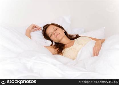 Bedroom - young woman sleeping and dreaming in white bed