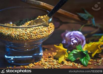 Bee pollen. In a glass container with a spoon