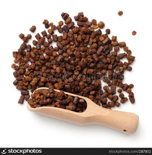 Bee pollen propolis in wooden scoop isolated on white background. Top view