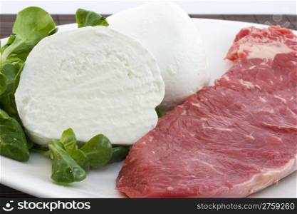 Beef and mozzarella. photo of a raw beef with a fresh mozzarella