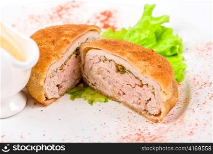 Beef cutlet closeup stuffed with bacon on white plate