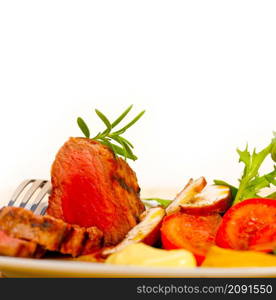 beef filet mignon grilled with fresh vegetables on side ,mushrooms tomato and arugula salad