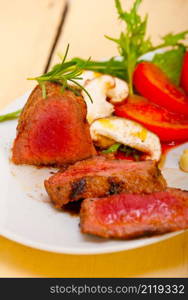 beef filet mignon grilled with fresh vegetables on side ,mushrooms tomato and arugula salad