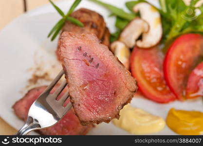 beef filet mignon grilled with fresh vegetables on side ,mushrooms tomato and arugula salad