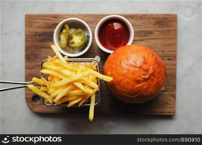 Beef Hamburger with fries and ketchup on wood bard , fast food
