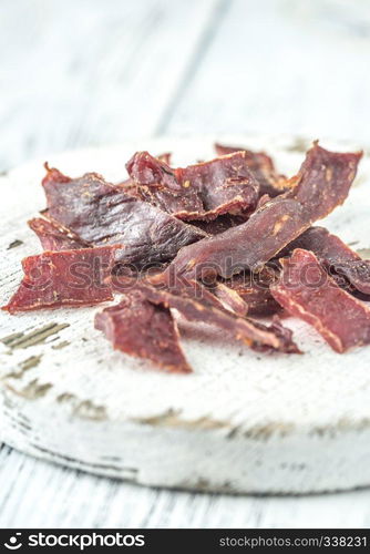 Beef jerky on the white wooden board