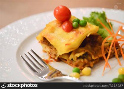 Beef lasagna , served with tomato and fresh vegetable