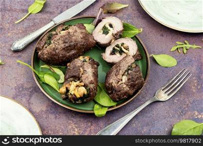 Beef meat rolls stuffed with mushrooms and green. Delicious beef roll filled. Tasty beef roulades on a plate