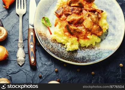 Beef meat stew in sauce with mashed potatoes. Homemade goulash. Stewed meat with potatoes