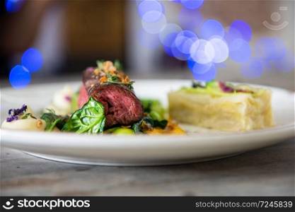 Beef meat with green peas, sweet potato mousse, roasted spinach and zucchini gratin. Beef meat with vegetables