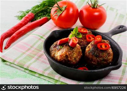 Beef meatballs with chili pepper served in skillet . Beef meatballs with chili pepper served in skillet. Grilled bbq meatloaf. Barbecue meatballs.