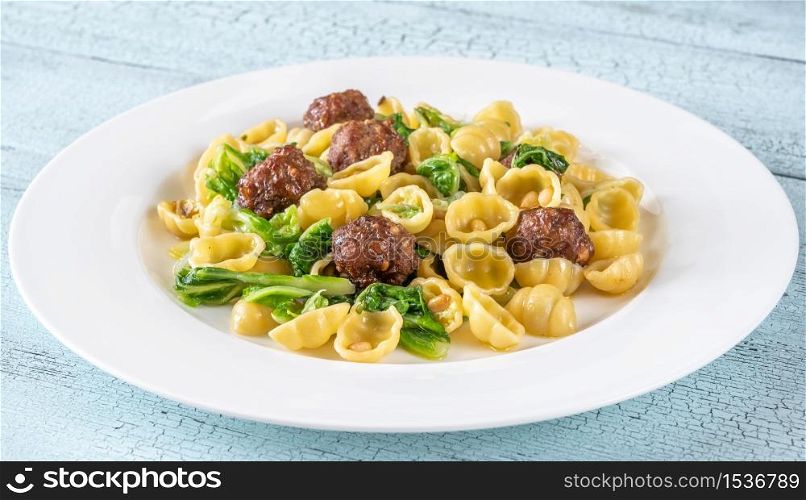 Beef meatballs with pasta, kale and pine nuts