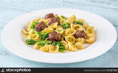 Beef meatballs with pasta, kale and pine nuts
