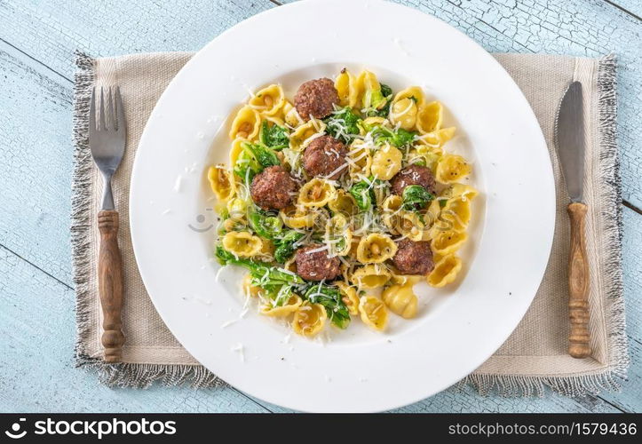 Beef meatballs with pasta, kale and pine nuts