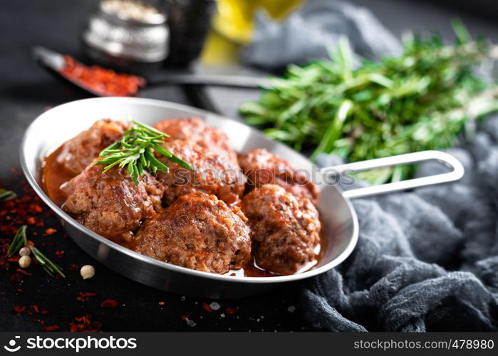 Beef meatballs with spices in tomato sauce