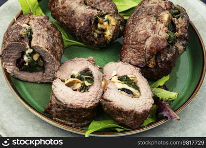 Beef rolls stuffed with mushrooms and herbs. Roasted meat. Delicious beef roll filled