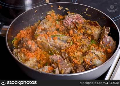 Beef sliced meat cooking in frying pan