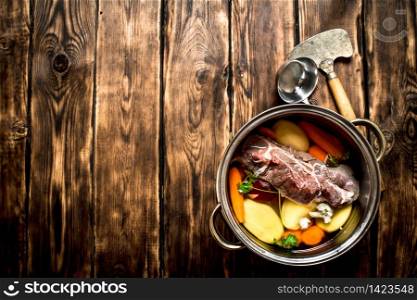 Beef soup with fresh vegetables. On wooden background.. Beef soup with fresh vegetables.
