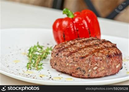 beef steak at plate. grilled beef steak with herbs and pepper