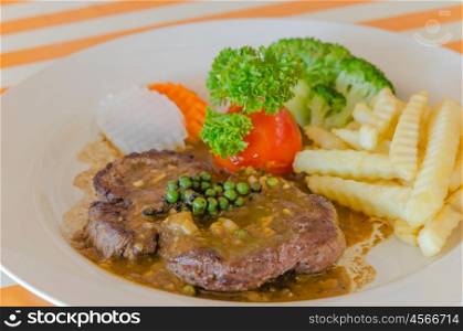 beef steak. close up beef steak with green peppercorn sauce