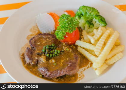 beef steak. close up beef steak with green peppercorn sauce