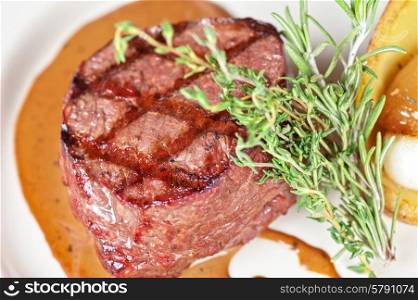 beef steak. grilled beef steak with herbs and vegetables